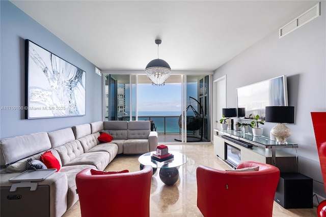 living room featuring visible vents, marble finish floor, and a chandelier