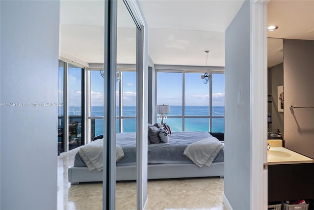 bedroom featuring a sink and a water view