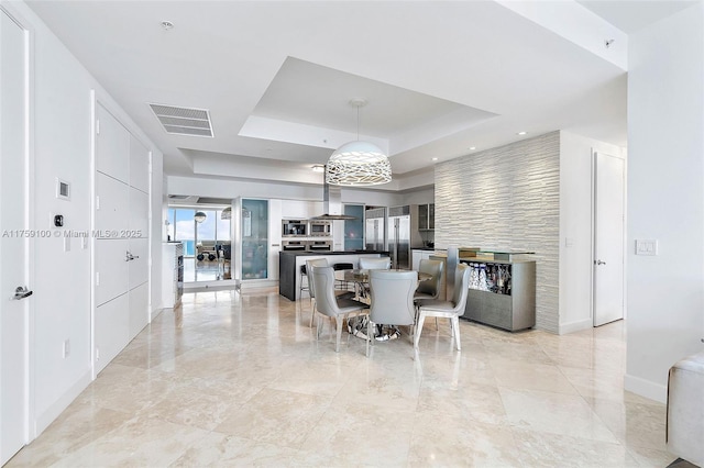 18201 Collins Ave Unit 4404, Sunny Isles Beach, FL 33160 - dining room featuring a raised ceiling, light marble finish flooring, and recessed lighting