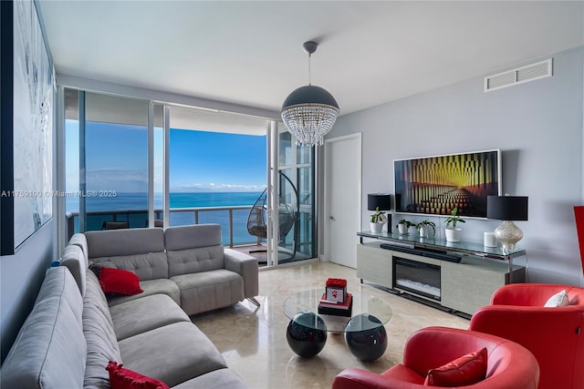 living room featuring visible vents and an inviting chandelier