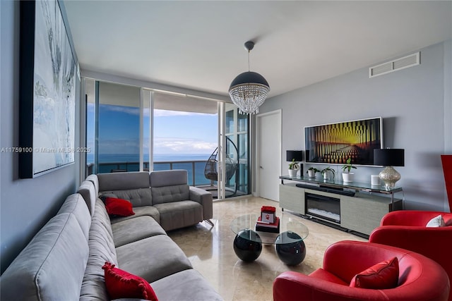 living room with a wall of windows, a notable chandelier, and visible vents