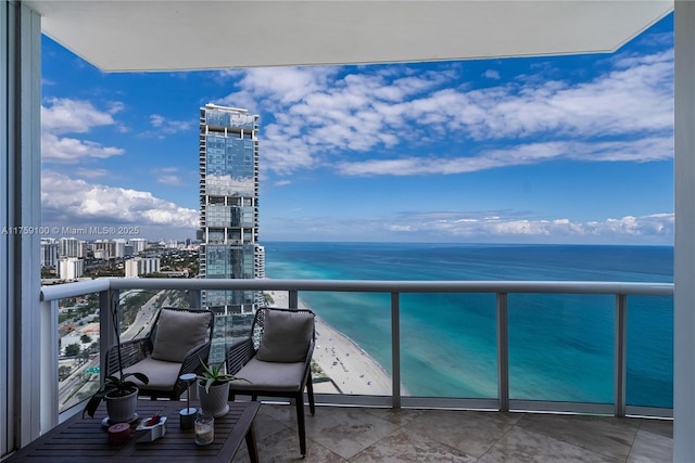 balcony with a water view and a view of city