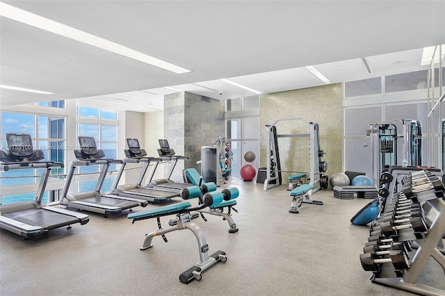 18201 Collins Ave Unit 4404, Sunny Isles Beach, FL 33160 - exercise room featuring a towering ceiling and floor to ceiling windows