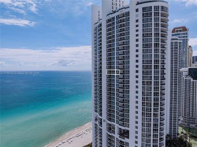 exterior space featuring a water view and a beach view