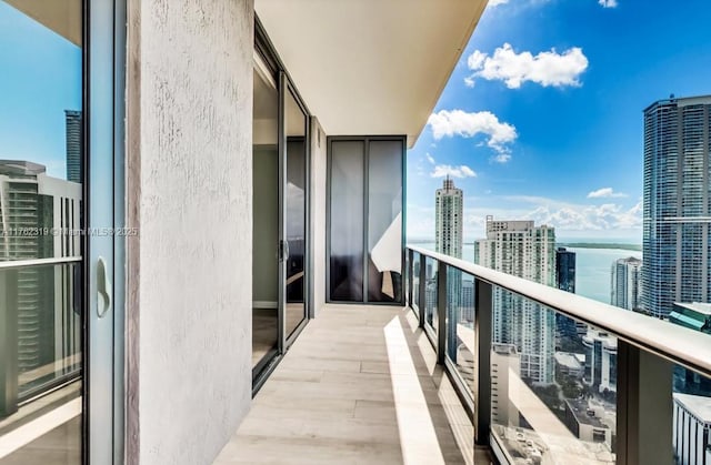 balcony featuring a city view and a water view