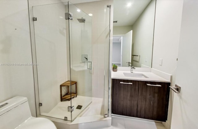 bathroom featuring vanity, toilet, and a stall shower