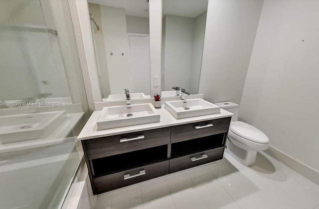 full bath with double vanity, tile patterned flooring, toilet, and a sink