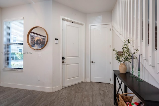 entrance foyer featuring baseboards and wood finished floors