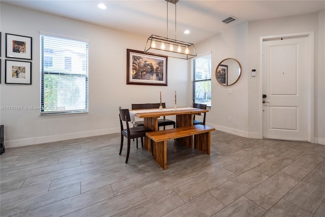 dining space with visible vents, plenty of natural light, baseboards, and light wood-style flooring