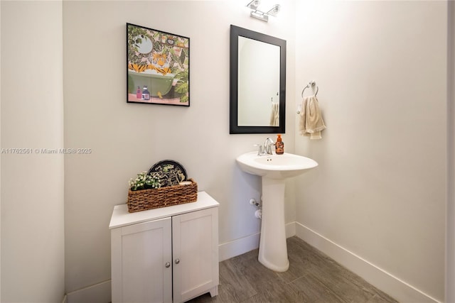 bathroom featuring baseboards and wood finished floors