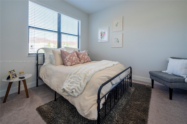 bedroom featuring baseboards and carpet floors