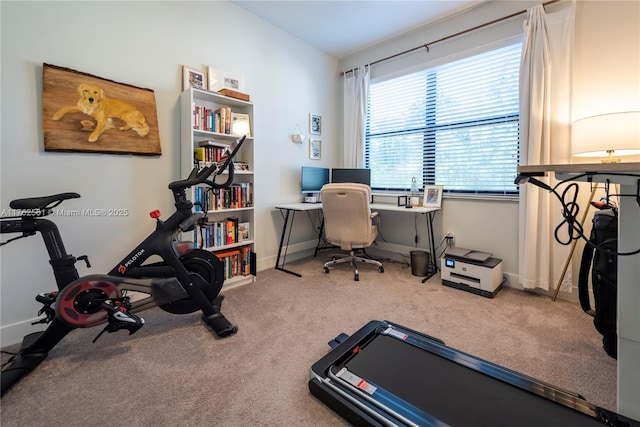 carpeted office space featuring baseboards