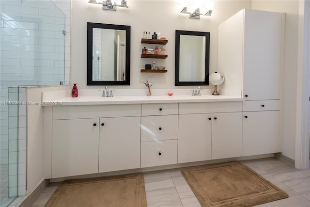 full bathroom with a sink, tiled shower, and double vanity