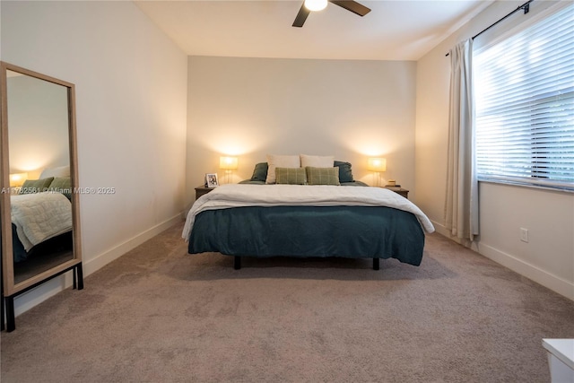 bedroom with a ceiling fan, light colored carpet, and baseboards