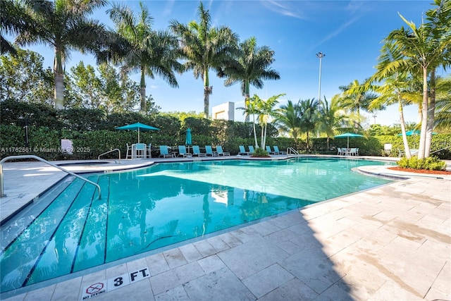 pool featuring fence and a patio area