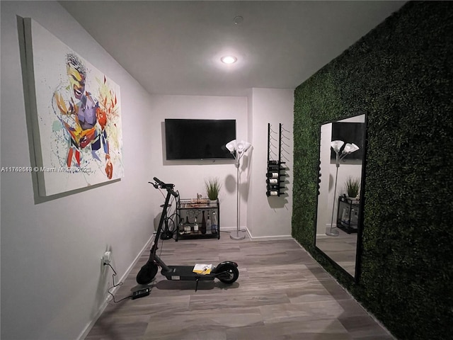 hallway featuring recessed lighting, baseboards, and wood finished floors