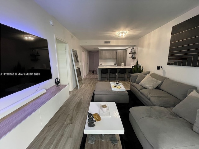 living room with visible vents and wood finished floors