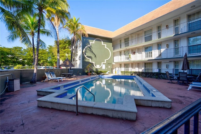 view of pool featuring fence and a patio area