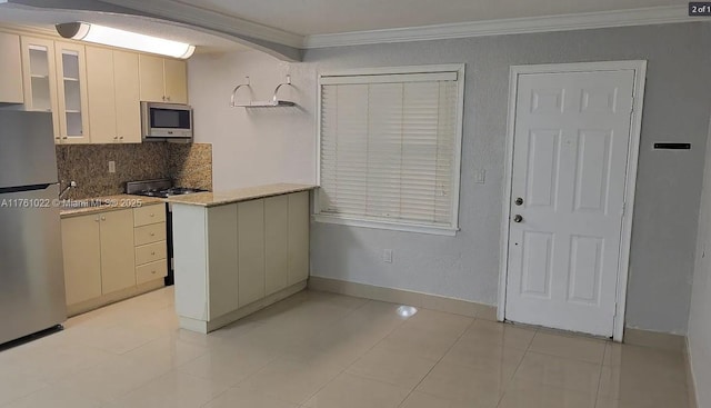 kitchen with glass insert cabinets, baseboards, ornamental molding, decorative backsplash, and appliances with stainless steel finishes