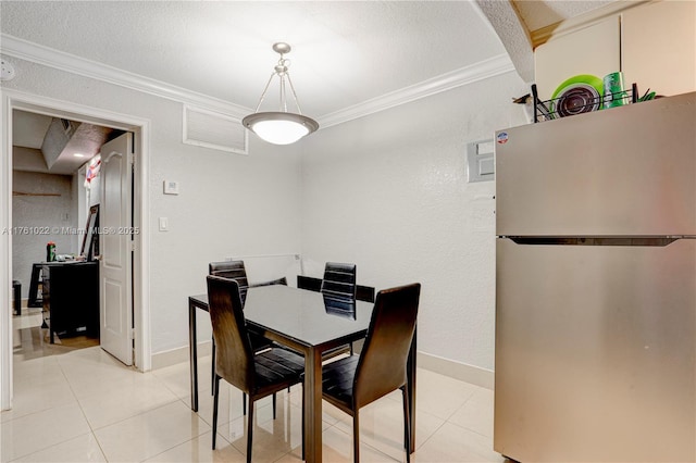 dining space with light tile patterned floors, visible vents, baseboards, and crown molding