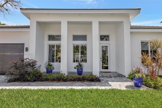 4440 NE 15th Ter, Oakland Park, FL 33334 - doorway to property featuring a tile roof, stucco siding, and a porch