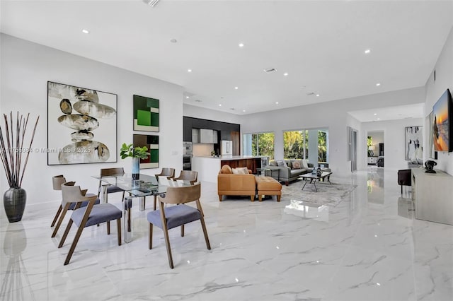 dining room featuring recessed lighting and marble finish floor