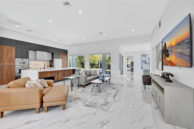 living area featuring visible vents, recessed lighting, and marble finish floor