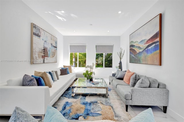 living area featuring marble finish floor and baseboards