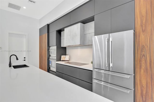 4440 NE 15th Ter, Oakland Park, FL 33334 - kitchen with gray cabinets, a sink, stainless steel appliances, and visible vents