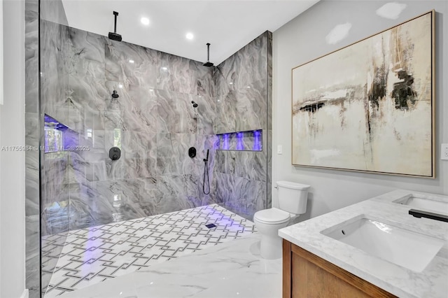 full bathroom with a marble finish shower, toilet, double vanity, marble finish floor, and a sink