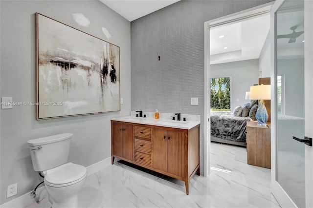 ensuite bathroom featuring toilet, marble finish floor, a sink, ensuite bath, and double vanity