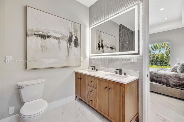 4440 NE 15th Ter, Oakland Park, FL 33334 - bathroom featuring baseboards, marble finish floor, connected bathroom, and a sink