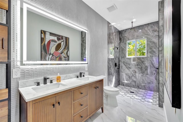 bathroom with visible vents, a marble finish shower, a sink, toilet, and marble finish floor