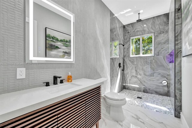 4440 NE 15th Ter, Oakland Park, FL 33334 - bathroom featuring toilet, vanity, a marble finish shower, marble finish floor, and tile walls