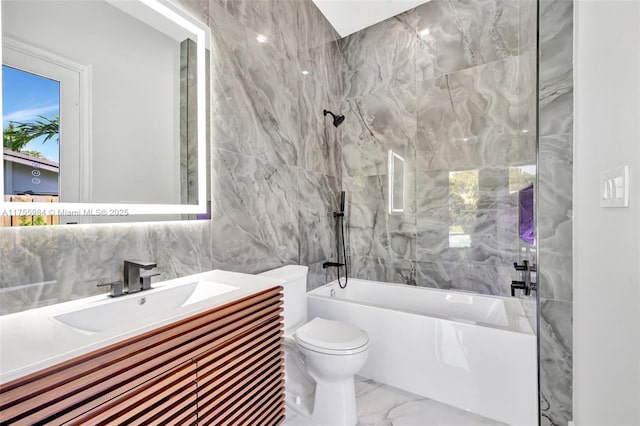 full bathroom featuring toilet, marble finish floor, vanity, tile walls, and shower / bathtub combination