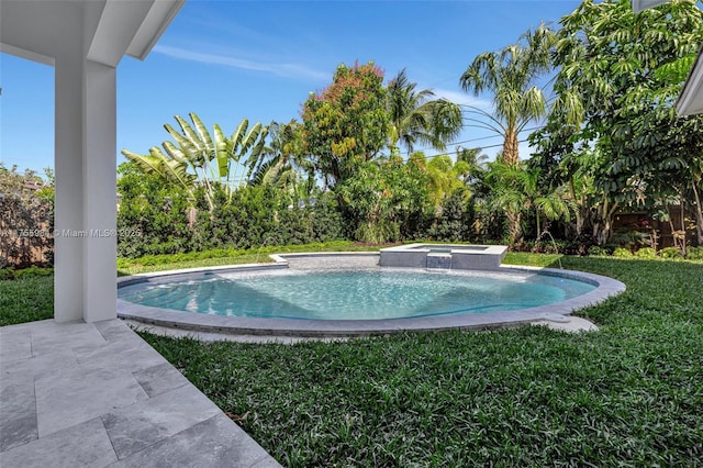 view of swimming pool with a patio area, a pool with connected hot tub, and a yard