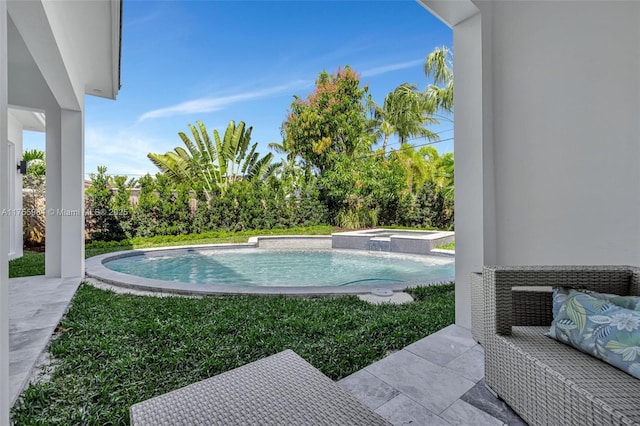 view of pool with a pool with connected hot tub