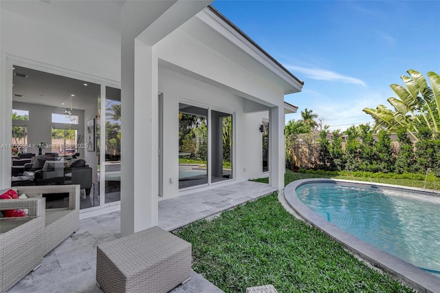 outdoor pool with a patio area and a lawn