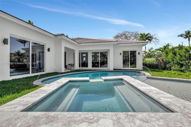 view of pool with a patio area and a pool with connected hot tub