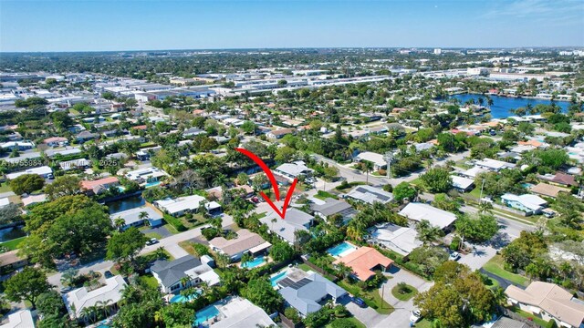 birds eye view of property with a residential view and a water view