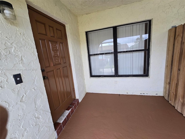 property entrance featuring stucco siding