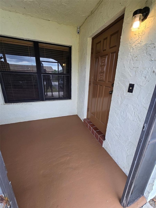 property entrance with stucco siding