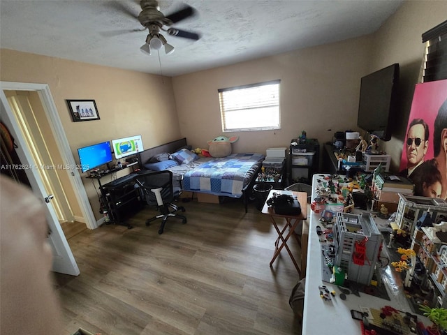 bedroom featuring a ceiling fan and wood finished floors