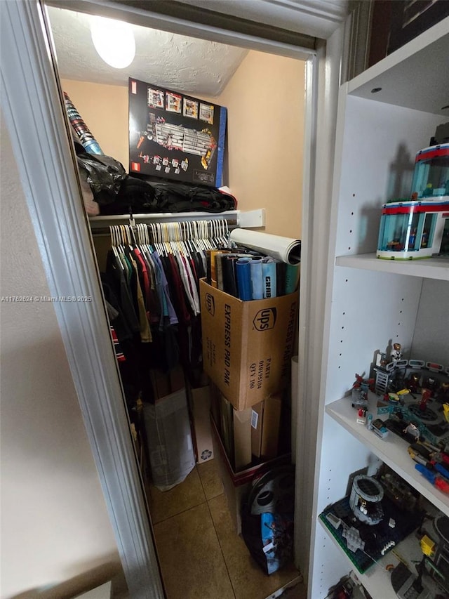 spacious closet featuring tile patterned flooring