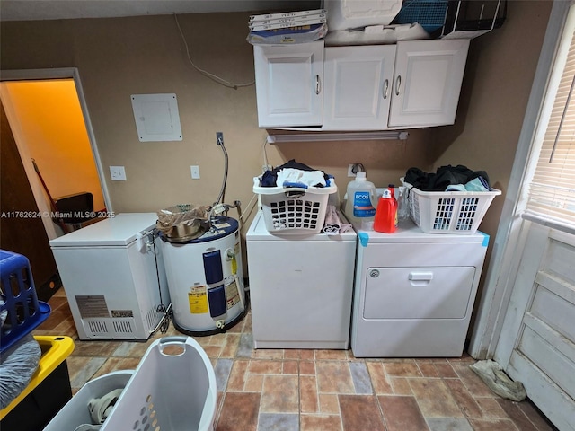 washroom with electric panel, stone finish flooring, electric water heater, washing machine and dryer, and cabinet space