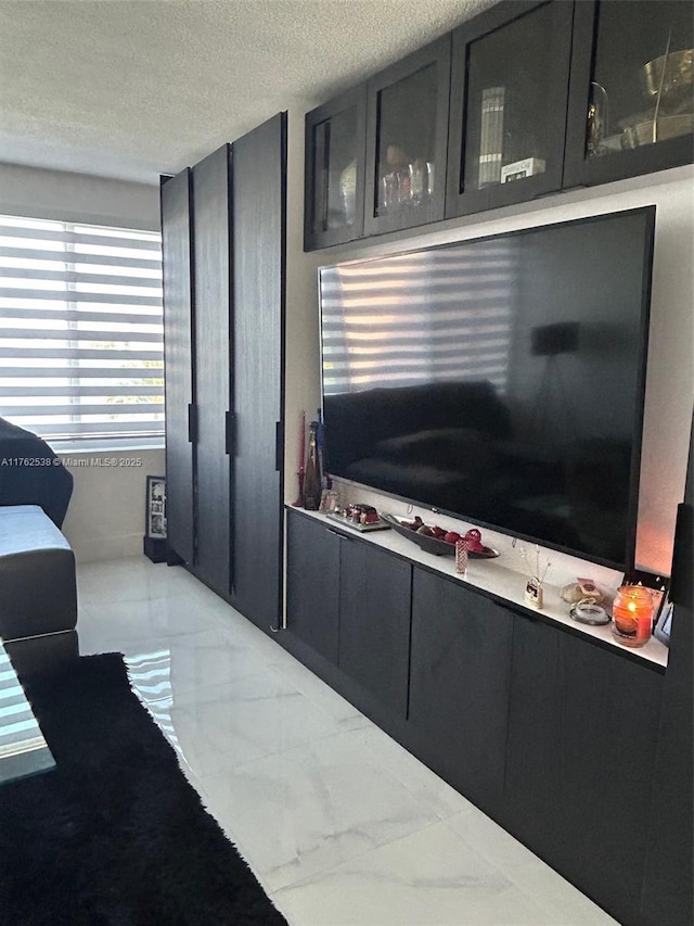 18555 NE 14th Ave Unit 609, Miami, FL 33179 - living area featuring marble finish floor and a textured ceiling