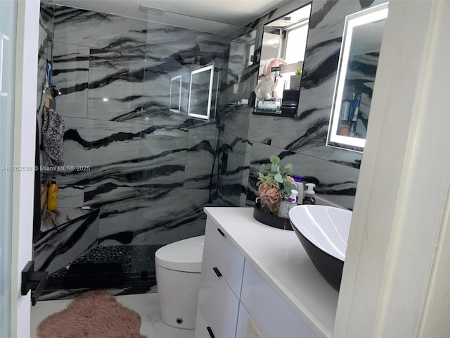 18555 NE 14th Ave Unit 609, Miami, FL 33179 - full bath featuring toilet, vanity, a marble finish shower, marble finish floor, and tile walls