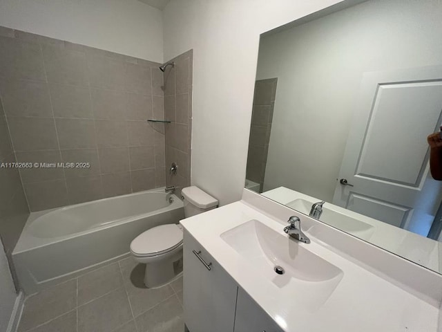 bathroom featuring tile patterned floors, toilet, vanity, and washtub / shower combination