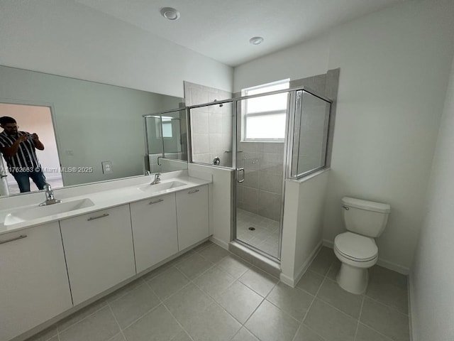 full bathroom featuring tile patterned flooring, a shower stall, double vanity, and a sink