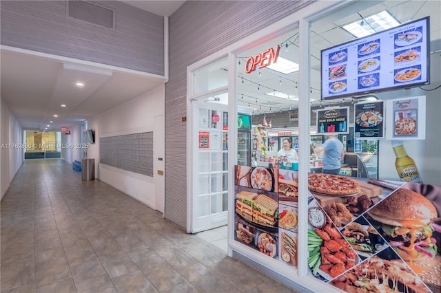 hallway featuring tile patterned flooring, mail area, and visible vents